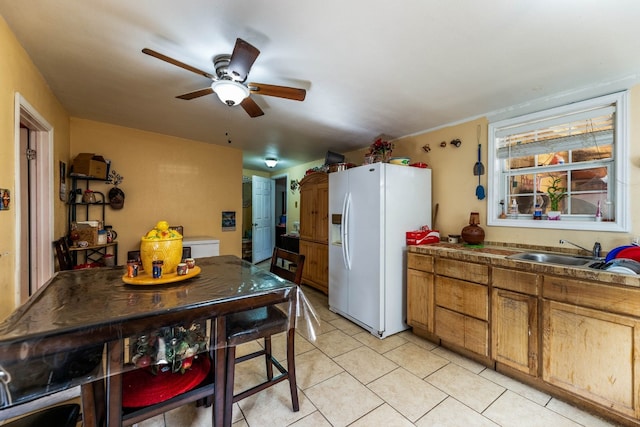 kitchen featuring white refrigerator with ice dispenser, ceiling fan, and sink