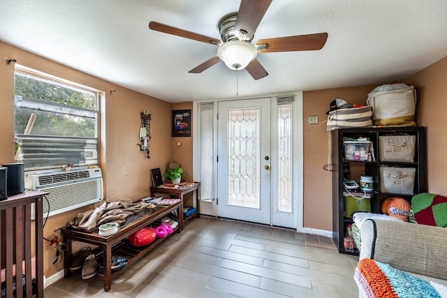 foyer entrance featuring hardwood / wood-style flooring, ceiling fan, and cooling unit