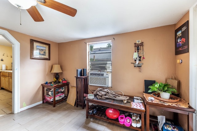 interior space with light hardwood / wood-style floors, cooling unit, and ceiling fan