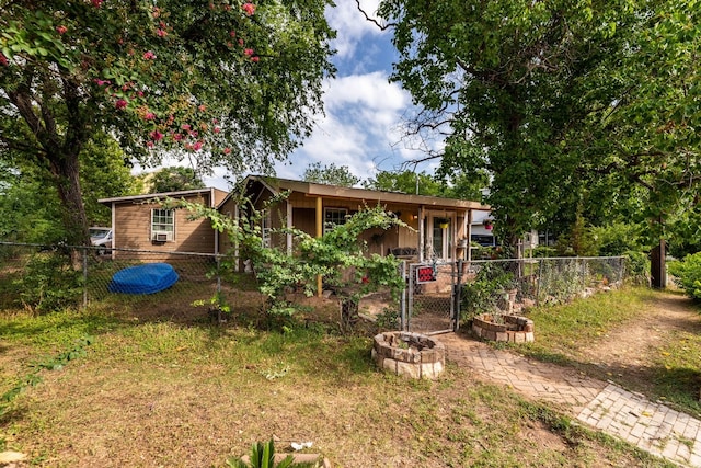 rear view of property featuring an outdoor fire pit