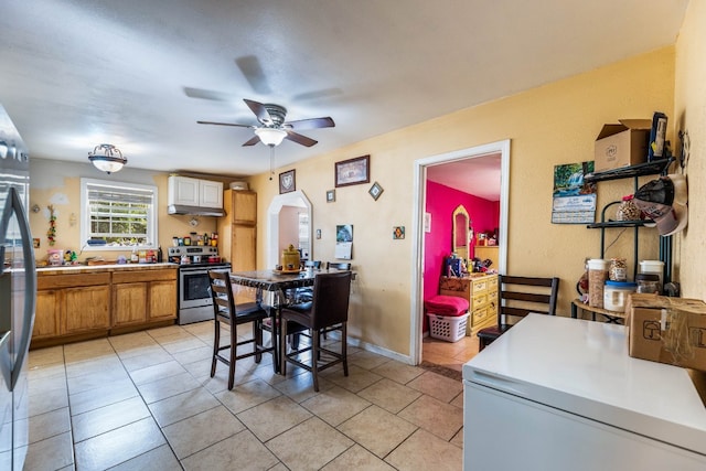 kitchen featuring ceiling fan, light tile patterned floors, and appliances with stainless steel finishes