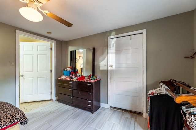 bedroom with ceiling fan and a closet