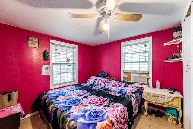 tiled bedroom featuring ceiling fan and cooling unit