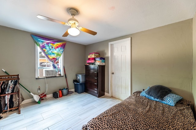 bedroom featuring ceiling fan and cooling unit