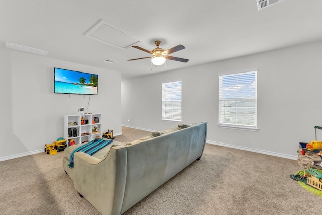 carpeted living room with ceiling fan