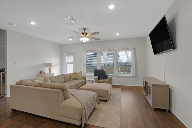 living room featuring ceiling fan, plenty of natural light, and dark hardwood / wood-style floors