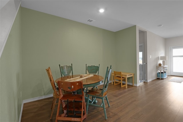 dining space with dark wood-type flooring