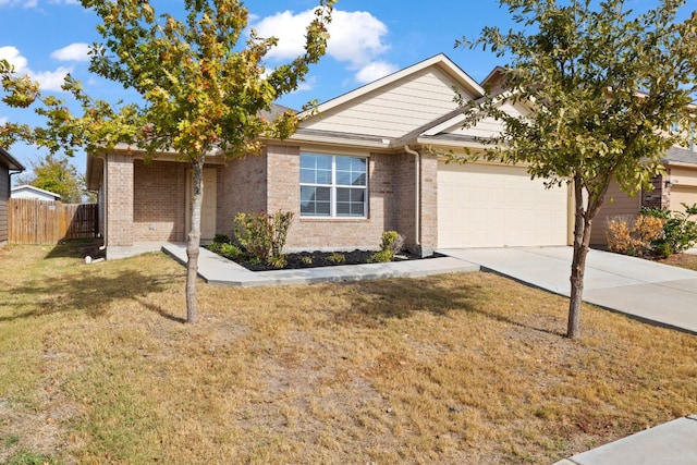 view of front of property with a front yard and a garage