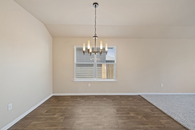 unfurnished dining area featuring a chandelier, dark wood-type flooring, and vaulted ceiling