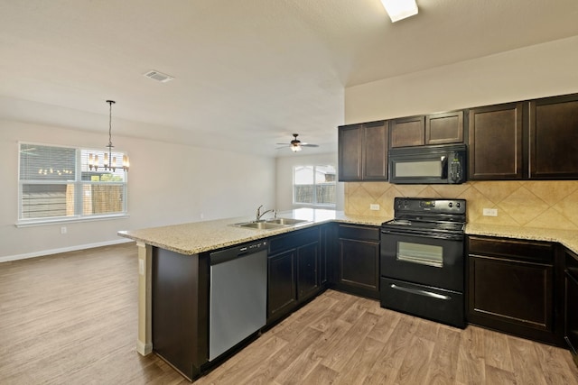 kitchen with sink, light hardwood / wood-style flooring, kitchen peninsula, decorative light fixtures, and black appliances