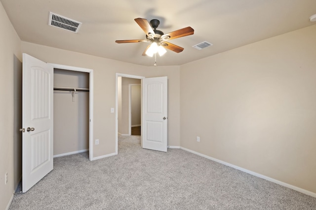 unfurnished bedroom with light carpet, a closet, and ceiling fan