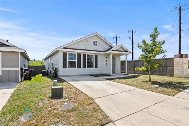 view of front of property with central AC unit and a front lawn