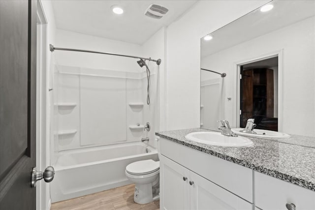 full bathroom featuring washtub / shower combination, toilet, vanity, and hardwood / wood-style flooring