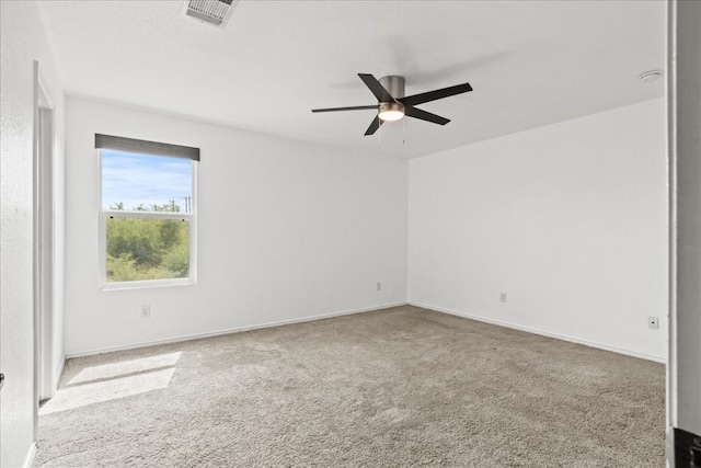 carpeted spare room with ceiling fan