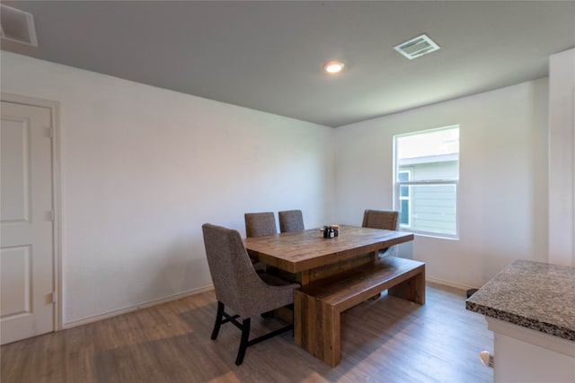 dining space with wood-type flooring