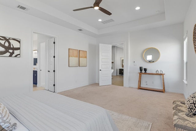 carpeted bedroom featuring a raised ceiling and ceiling fan