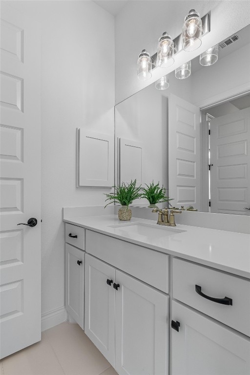 bathroom featuring tile patterned flooring and vanity