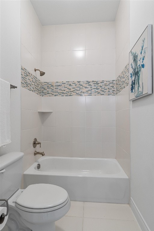 bathroom featuring tile patterned floors, tiled shower / bath combo, and toilet