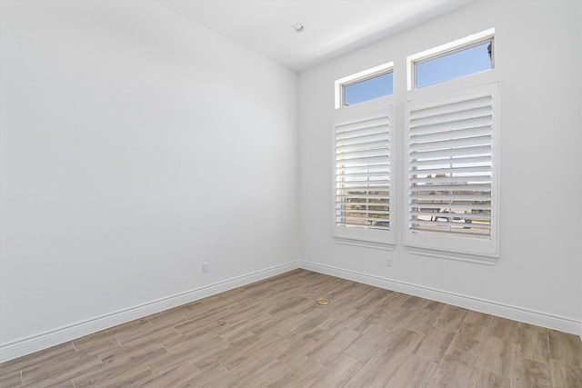 unfurnished room featuring plenty of natural light and light hardwood / wood-style flooring