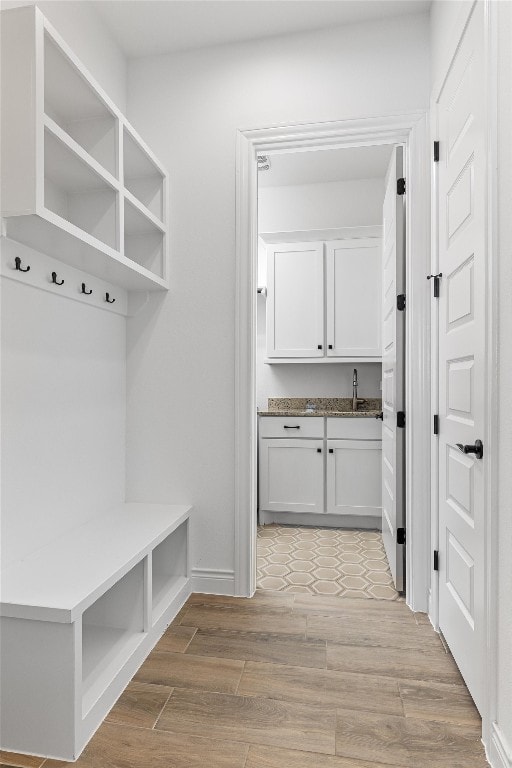 mudroom with light wood-type flooring and sink