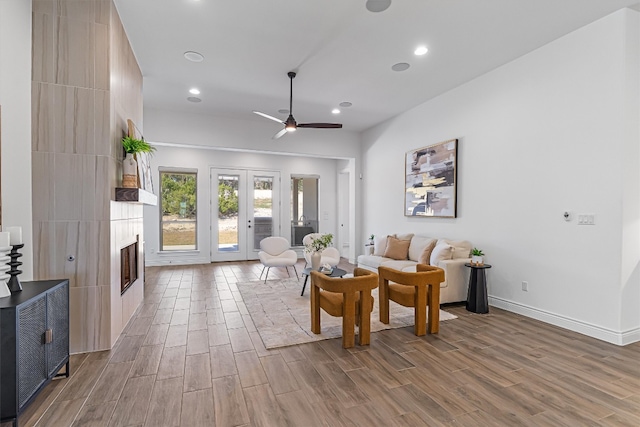 living room featuring ceiling fan, light wood-type flooring, and french doors