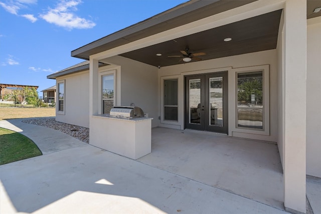 view of patio / terrace featuring french doors, an outdoor kitchen, grilling area, and ceiling fan