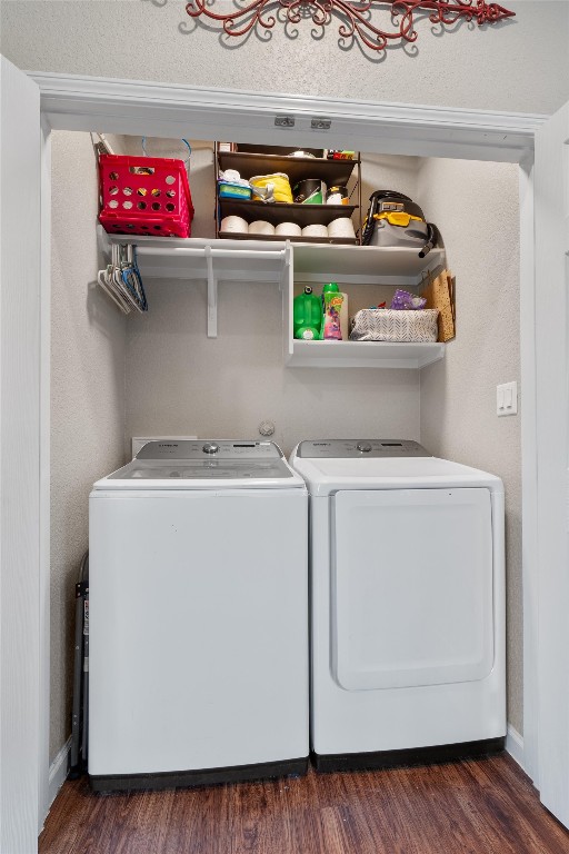 laundry room with dark hardwood / wood-style flooring and independent washer and dryer