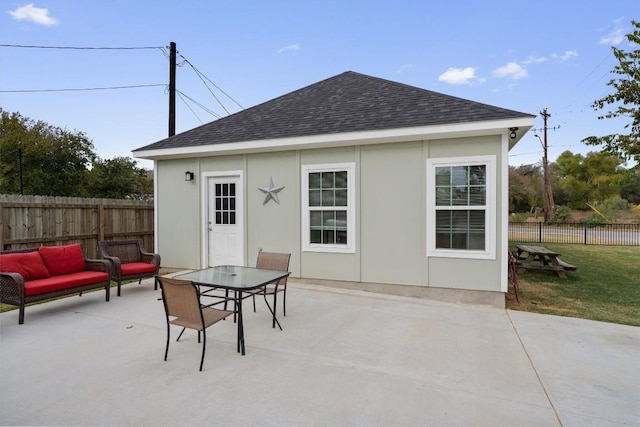 226 Spruce Ave, Luling, TX 78648 - rear view of house featuring a patio, a shingled roof, outdoor lounge area, and outdoor dining space