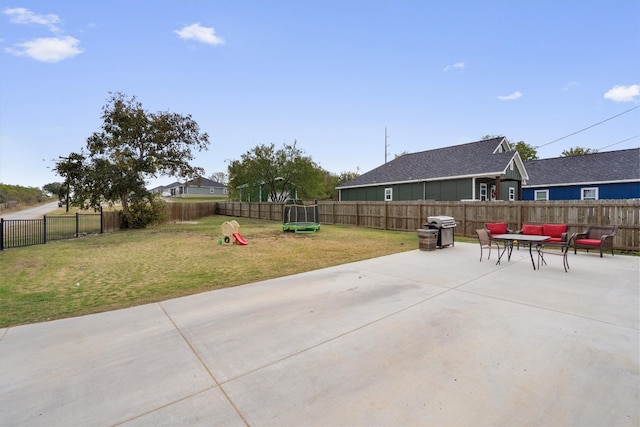 view of patio with area for grilling and a trampoline