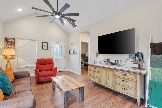 living room featuring ceiling fan, light hardwood / wood-style floors, and lofted ceiling