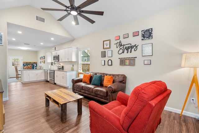 living room featuring hardwood / wood-style floors, plenty of natural light, and lofted ceiling