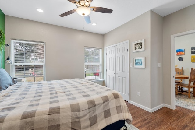 bedroom featuring ceiling fan, wood-type flooring, and a closet