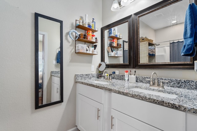 bathroom with a shower with shower curtain and vanity