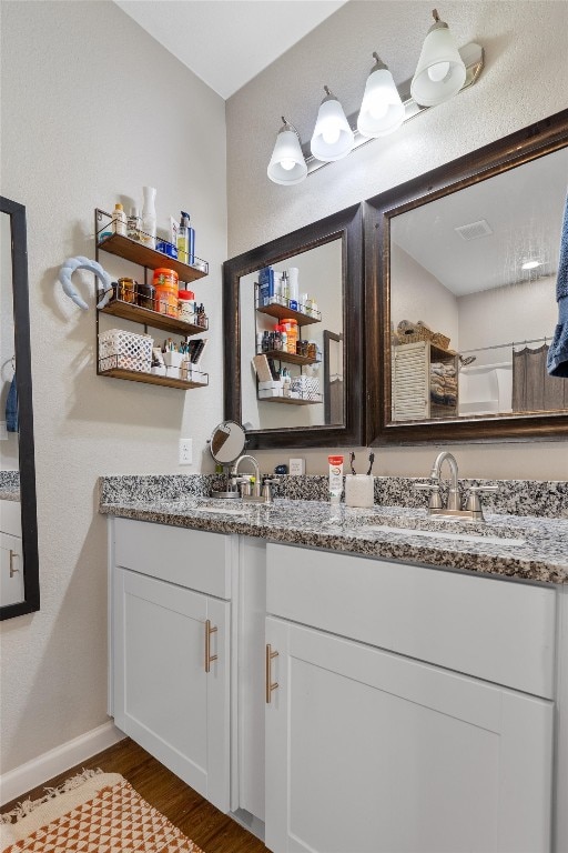 bathroom featuring vanity and hardwood / wood-style flooring