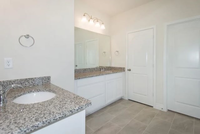 bathroom with tile patterned flooring and vanity