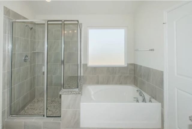 bathroom with shower with separate bathtub