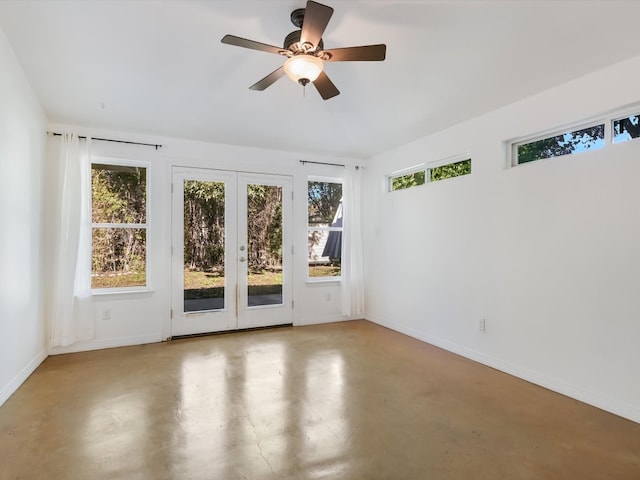 unfurnished room with ceiling fan and french doors