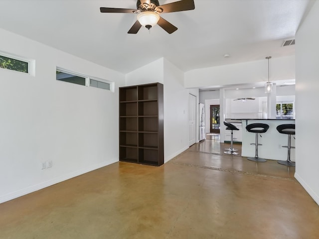 unfurnished living room with ceiling fan