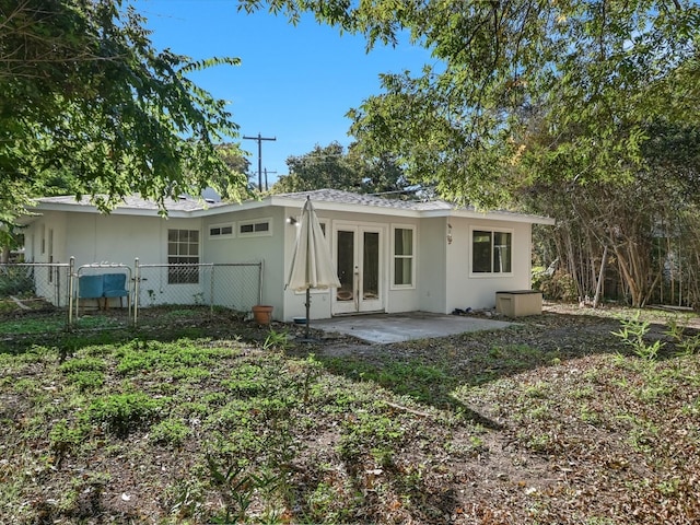 rear view of property featuring french doors and a patio area