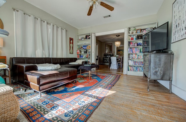 living room with ceiling fan and light wood-type flooring