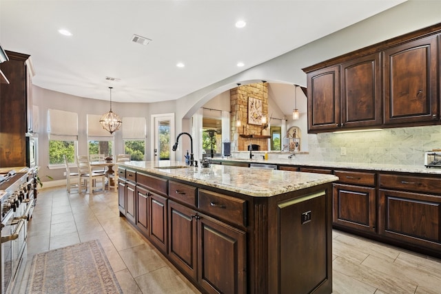 kitchen featuring a sink, visible vents, hanging light fixtures, appliances with stainless steel finishes, and tasteful backsplash