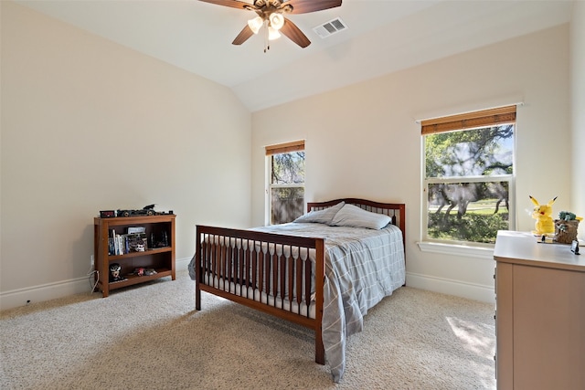 bedroom with light carpet, multiple windows, visible vents, and vaulted ceiling