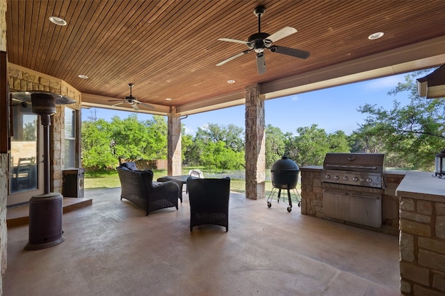 view of patio / terrace with ceiling fan, an outdoor kitchen, and grilling area