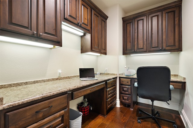 home office with baseboards, dark wood finished floors, and built in desk