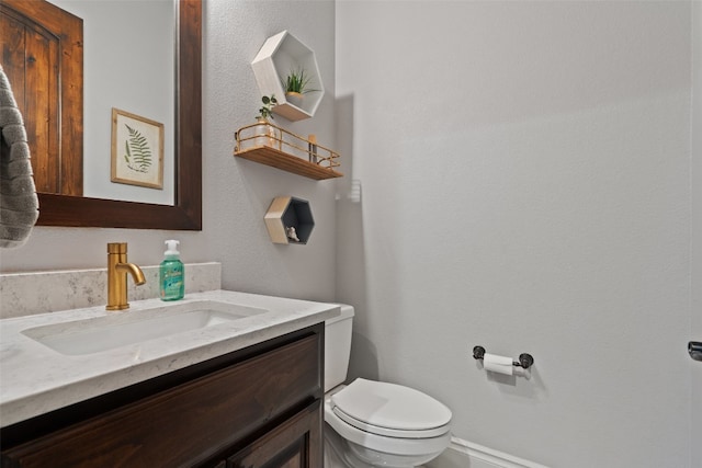 bathroom with toilet and vanity