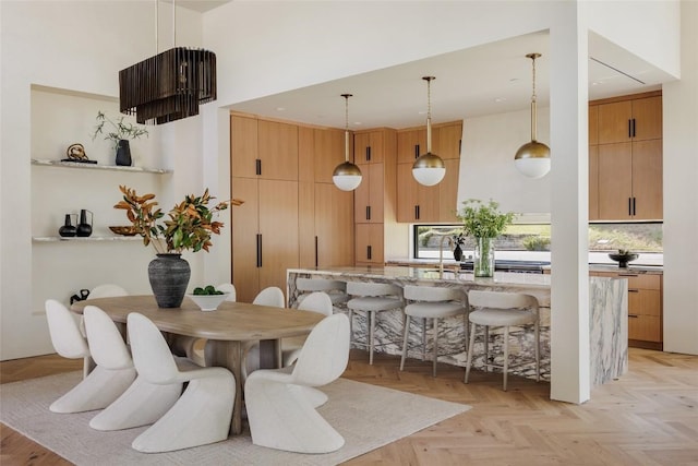 dining room with a towering ceiling