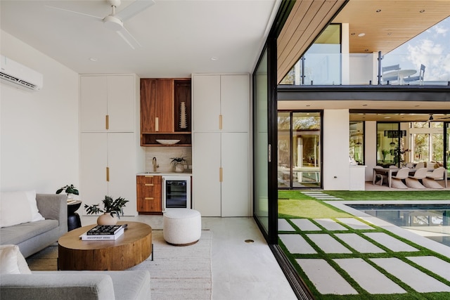 living room with ceiling fan, beverage cooler, sink, and a wall unit AC