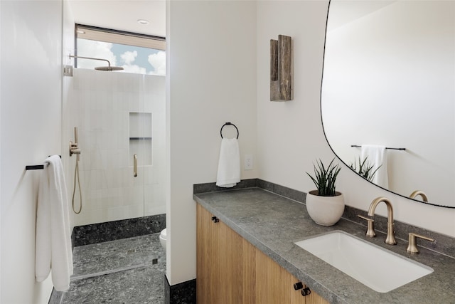 bathroom with vanity, toilet, and an enclosed shower