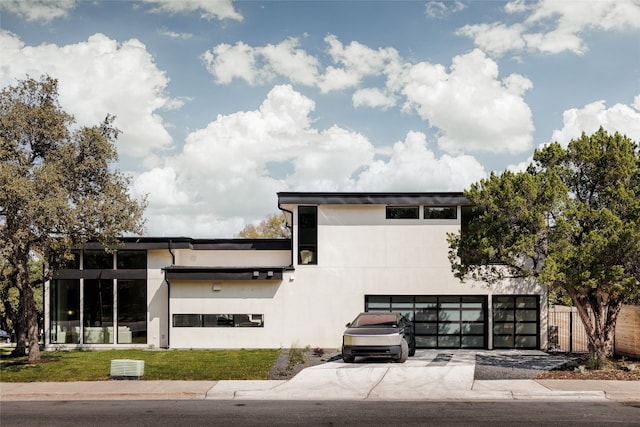 contemporary house with a garage and a front yard