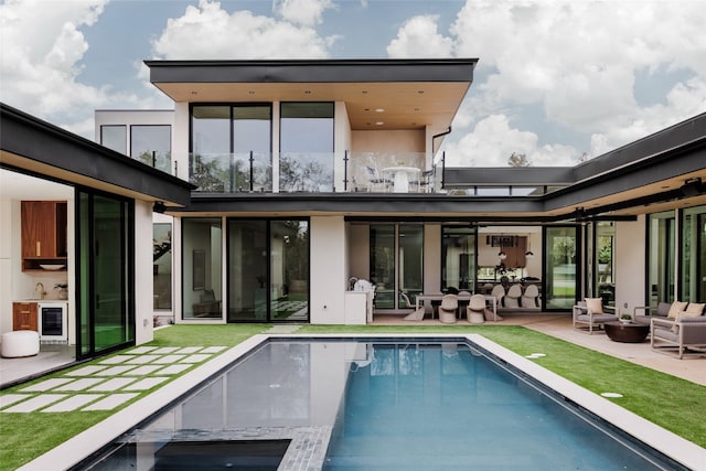 back of house featuring wine cooler, outdoor lounge area, and a patio